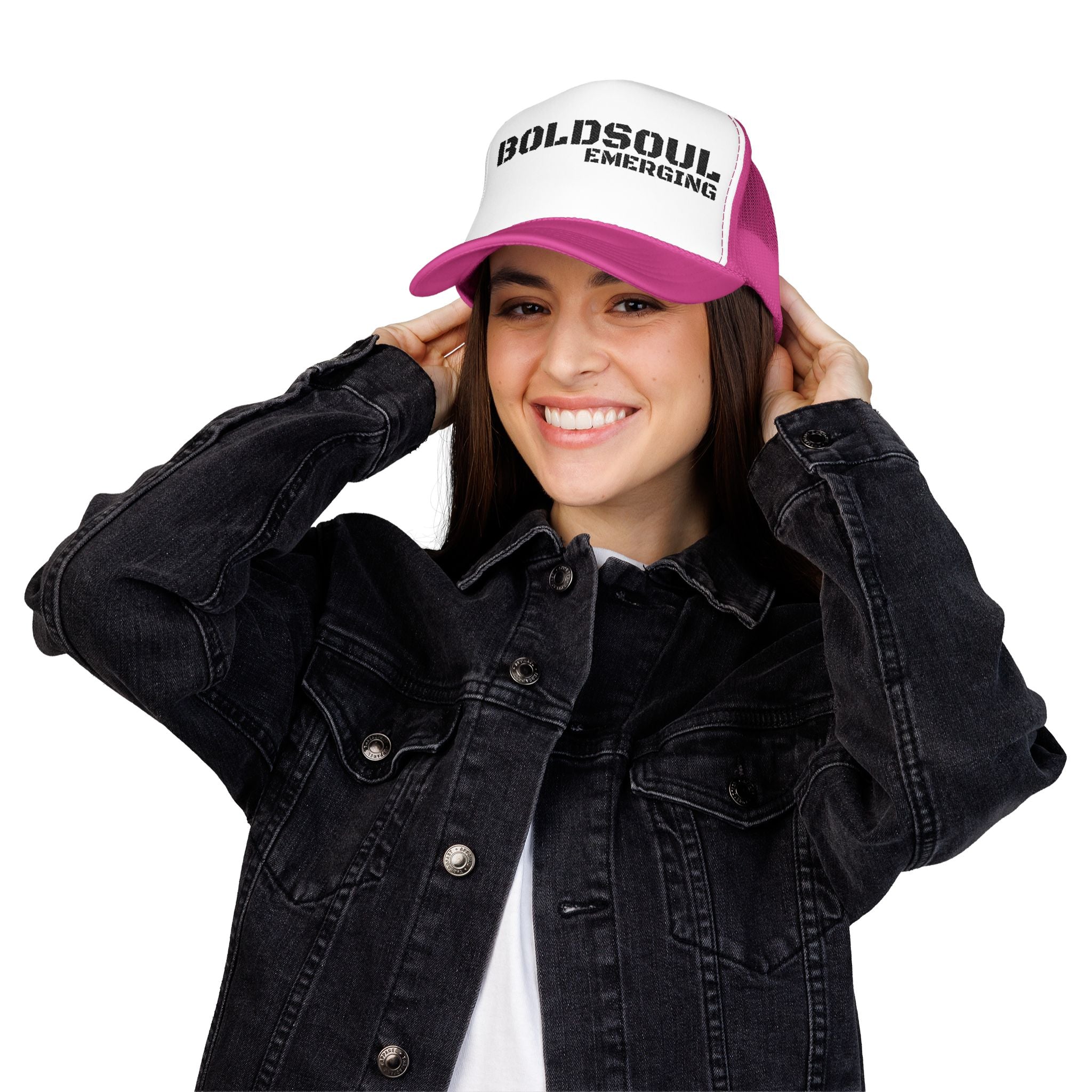 Model wearing BOLDSOUL foam trucker hat in white and hot pink with black text graphic, mesh back, and curved brim